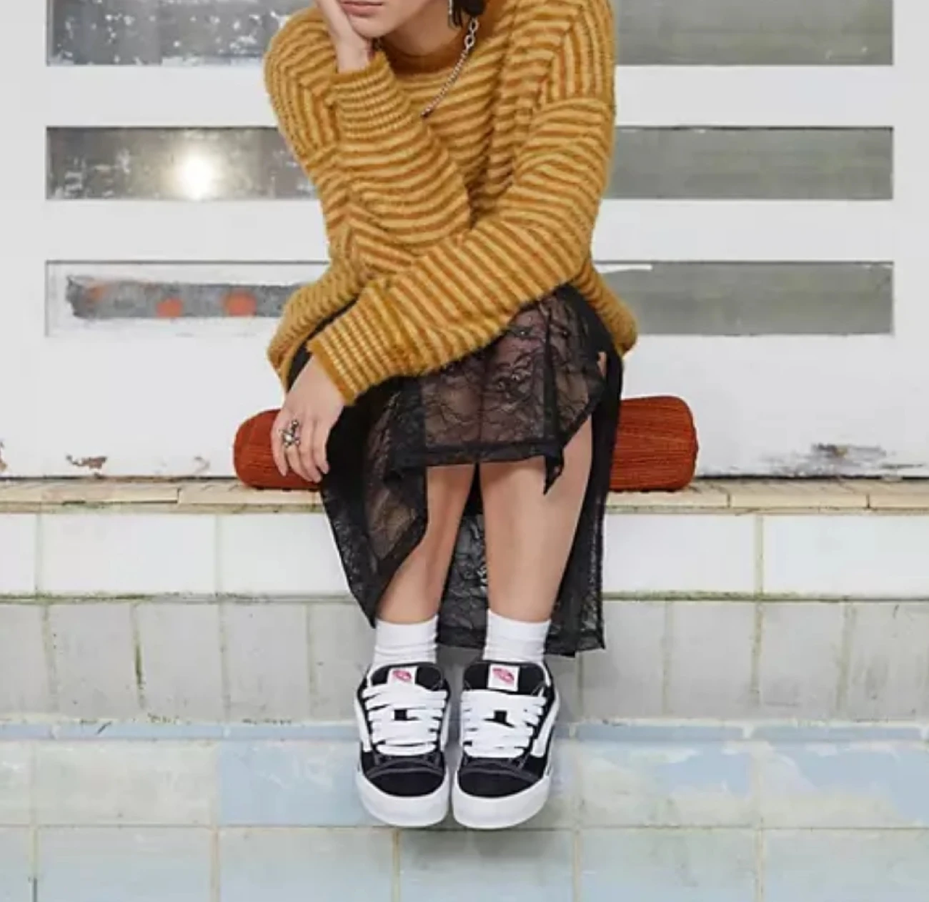 school nostalgia hit even gen-z as they enter the work force, and they become more creative on reliving those memories with the vans knu skool sneakers paired with stocking, jumpers, mini skirts