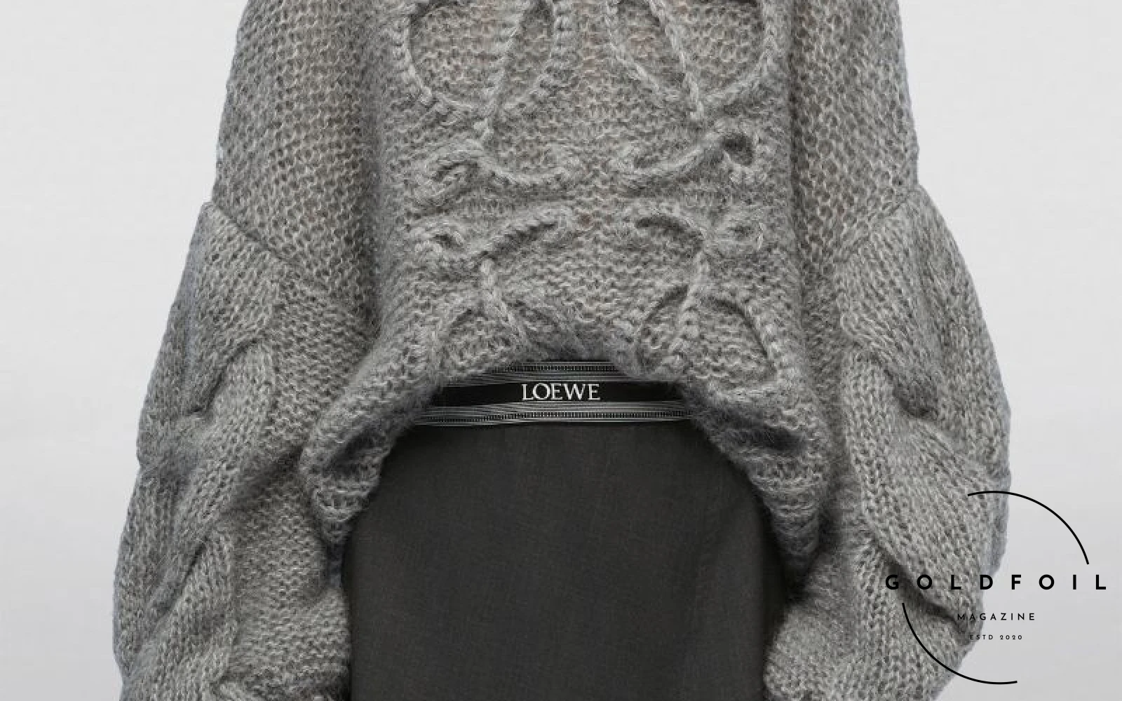 A model wearing a chunky grey knit mohair blend anagram sweater from Loewe A model wearing a chunky grey knit mohair blend anagram sweater from Loewe