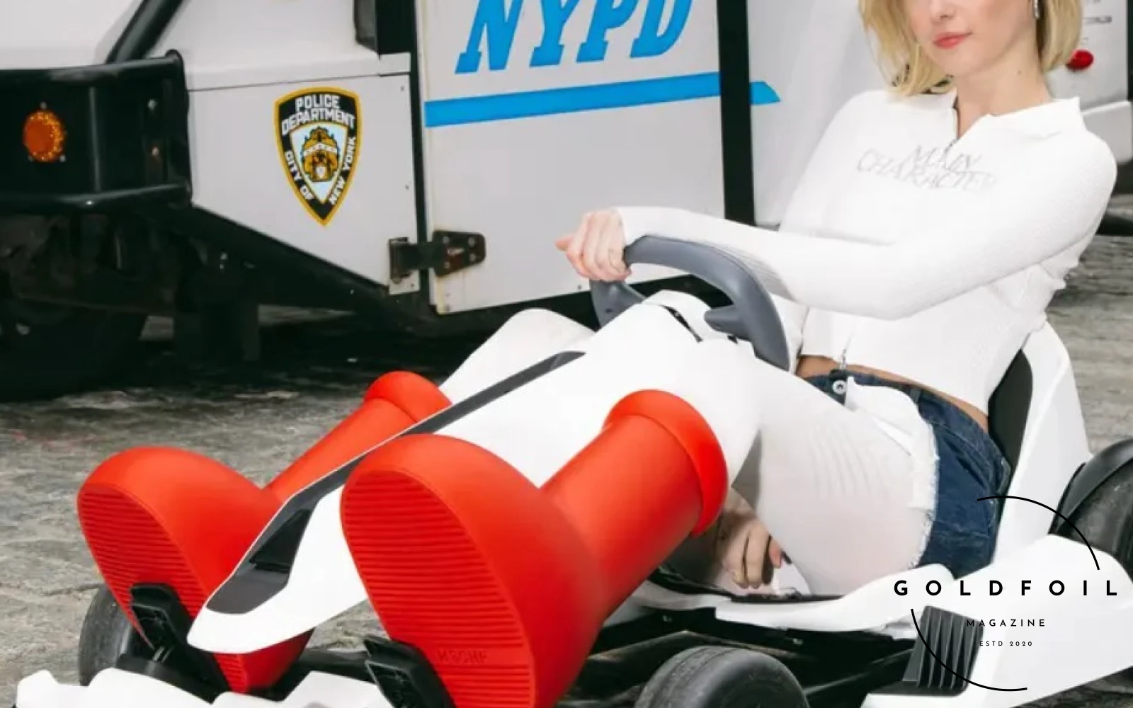 In this photo we see Sarah Snyder in a photoshoot for the iconic, sold out everywhere MSCHF red boots. The huge cartoon inspired boots took over social media by storm in the Spring of 2023 and continued to appear on red carpets and worn casually by celebrities and influencers In this photo we see Sarah Snyder in a photoshoot for the iconic, sold out everywhere MSCHF red boots. The huge cartoon inspired boots took over social media by storm in the Spring of 2023 and continued to appear on red carpets and worn casually by celebrities and influencers